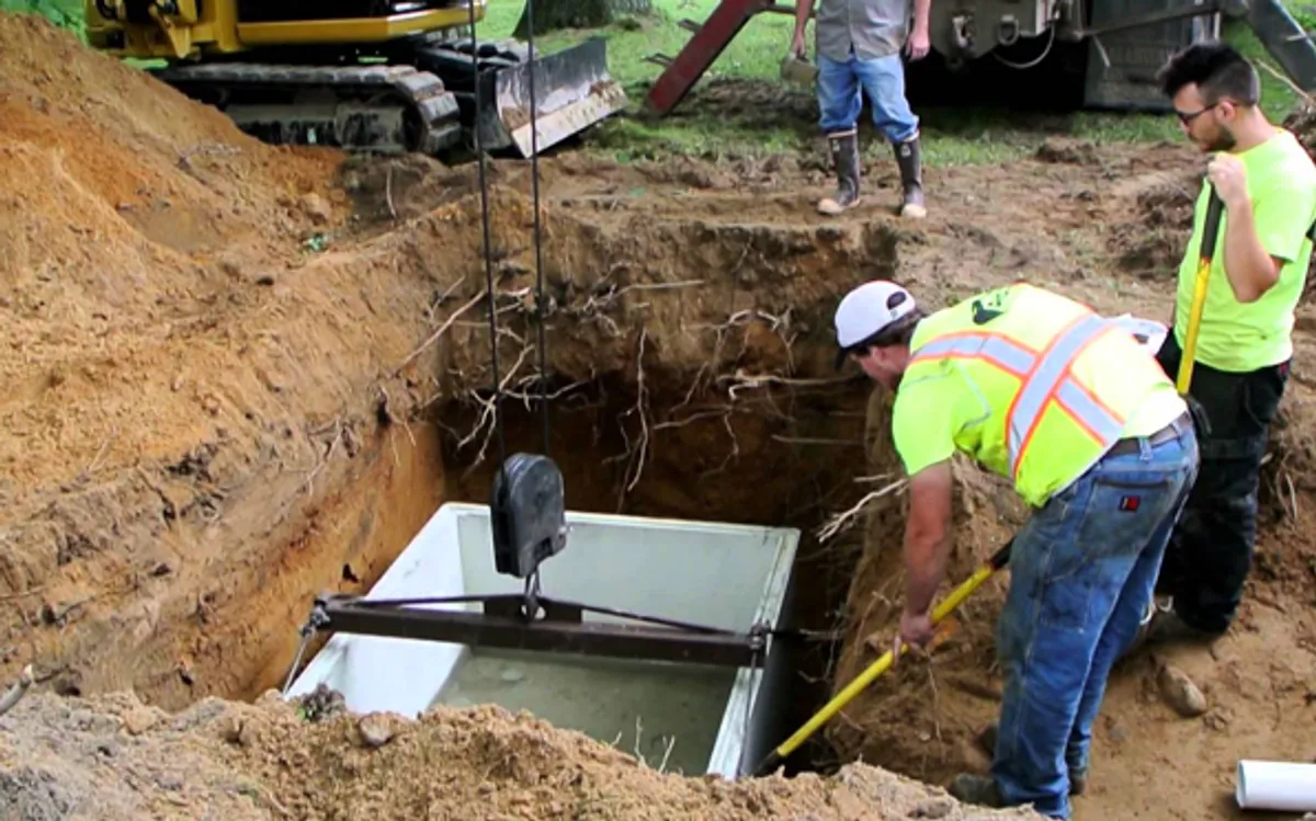 Heavy excavator preparing a residential site for foundation protection and drainage system installation in Atlanta, GA